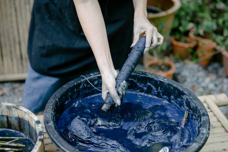 Person working with indigo dye bath