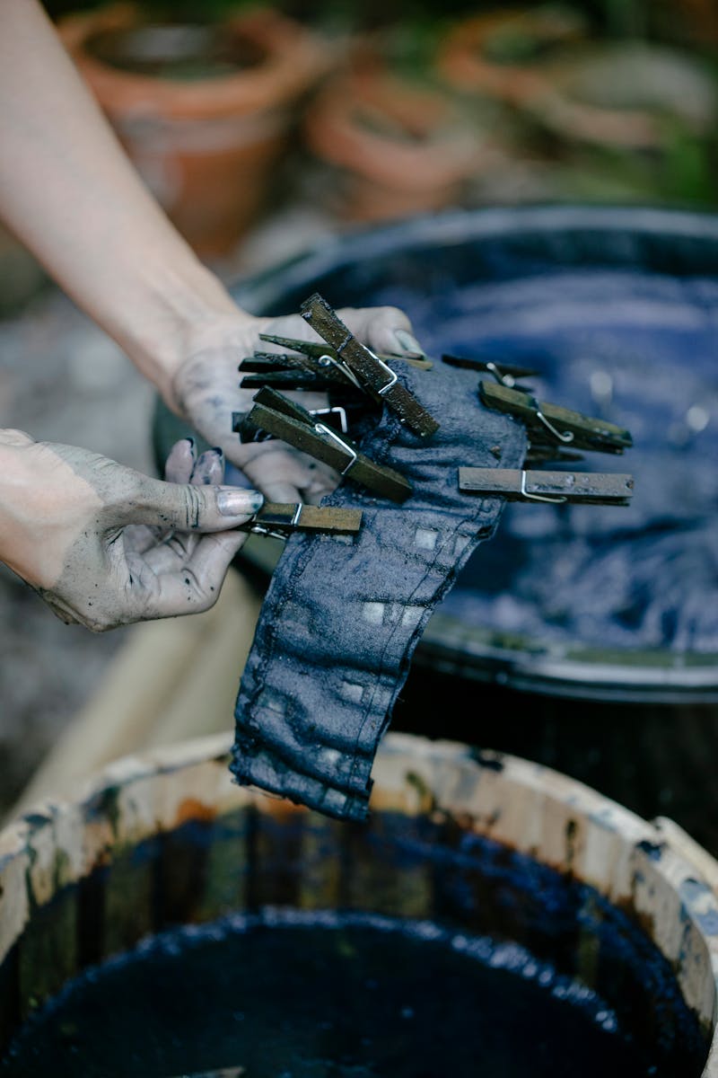 Hands holding indigo-dyed fabric