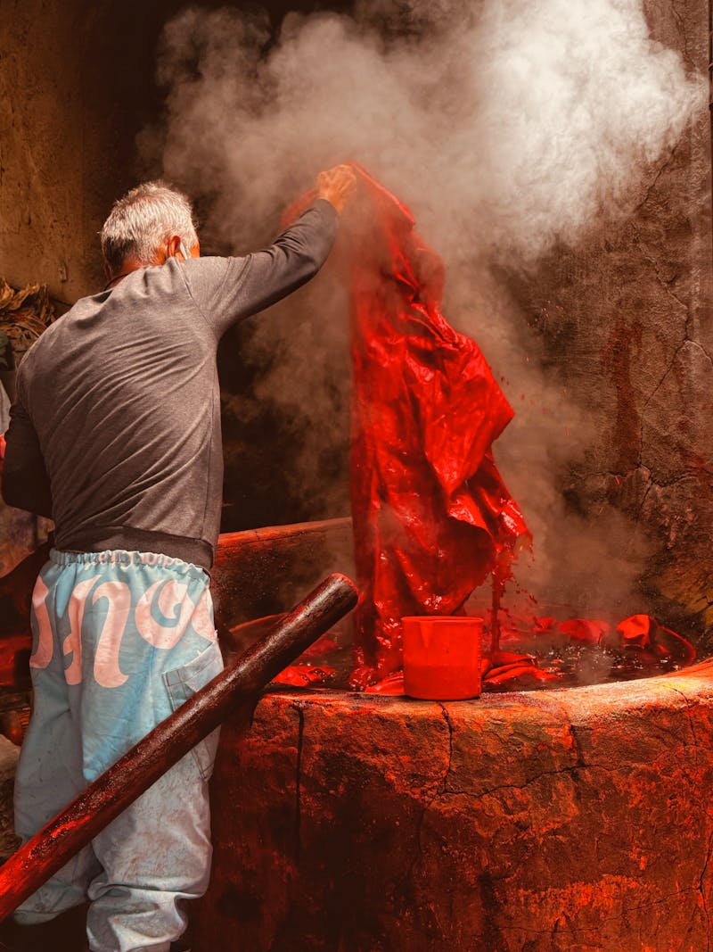 Person dyeing fabric in rich red